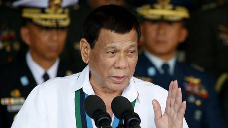 Former Philippines president charged with ‘crimes against humanity’